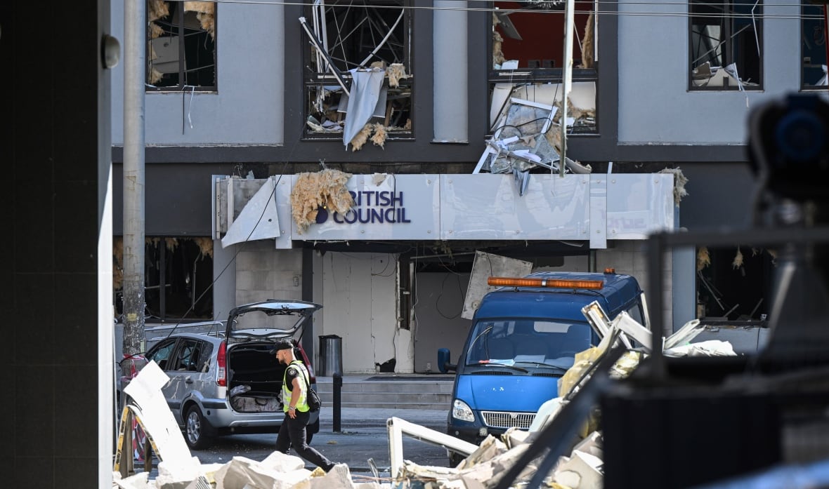 A building says "British Council" Windows and knees have been destroyed on the street. 