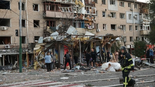 Local residents look at their destroyed home following Russian air strike in Zaporizhzhia, Ukraine, Saturday, Aug. 30, 2025. (AP Photo/Kateryna Klochko) Destroyed home