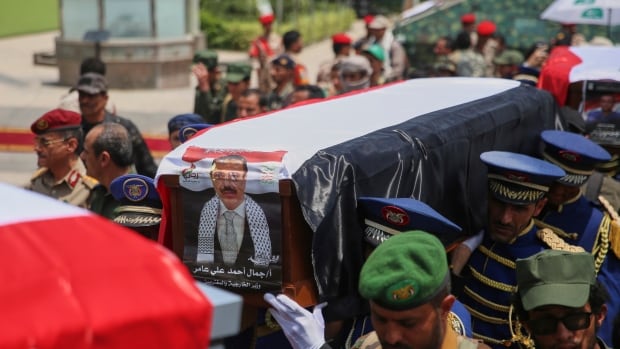 Honor guards carry the coffin of Houthi minister of foreign affairs Jamal Aamer and the coffins of other officials killed in Israeli airstrikes on Thursday, during a funeral ceremony at the Shaab Mosque in Sanaa, Yemen, Monday, Sept. 1, 2025. (AP Photo/Osamah Abdulrahman) casket being carried