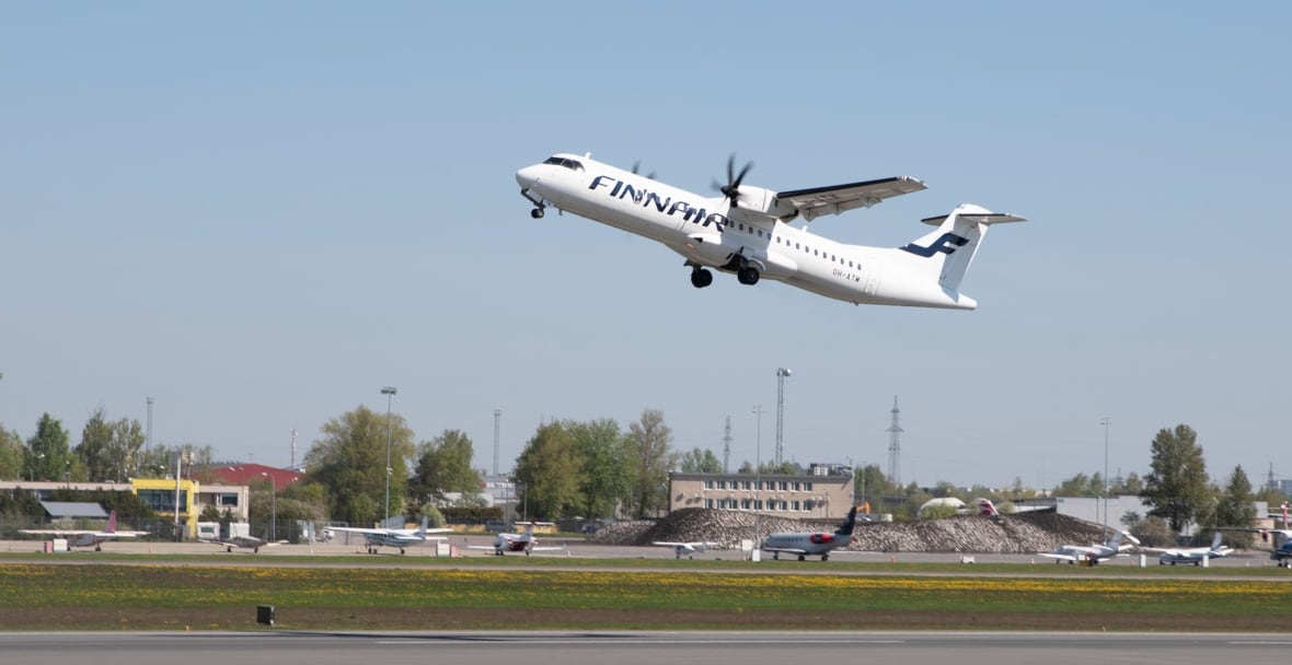 A plane takes off with Finnair on the side.