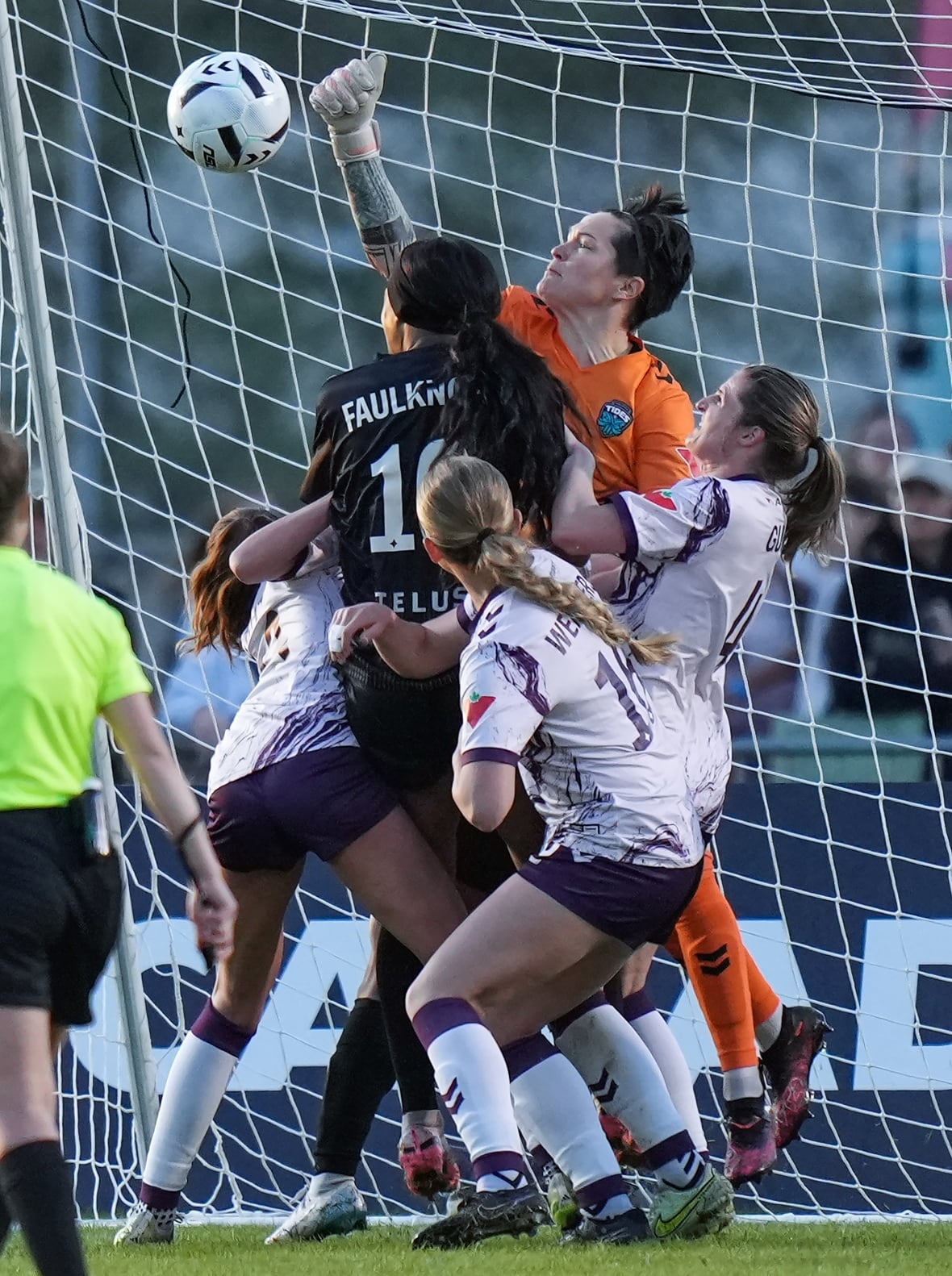 A soccer goalkeeper makes a save.