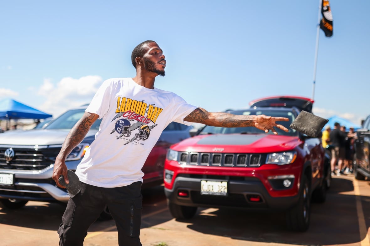 Former Hamilton Tiger-Cats player Brandon Banks plays Cornhole, also known regionally as sack toss, ahead of the CFL Labour Day Classic against the Toronto Argonauts in Hamilton on Monday, September 1, 2025.