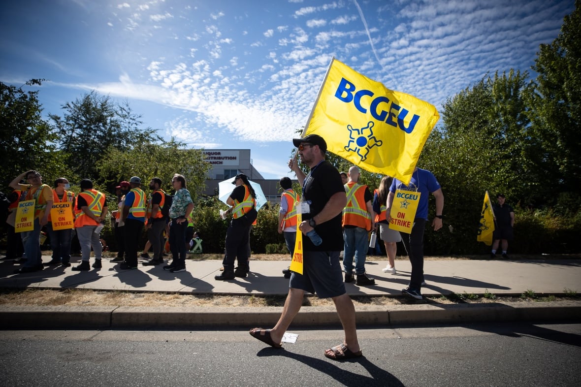 Members of the British Columbia General Employees' Union picket outside a B.C. Liquor Distribution Branch facility, in Delta, B.C., on Monday, August 15, 2022.