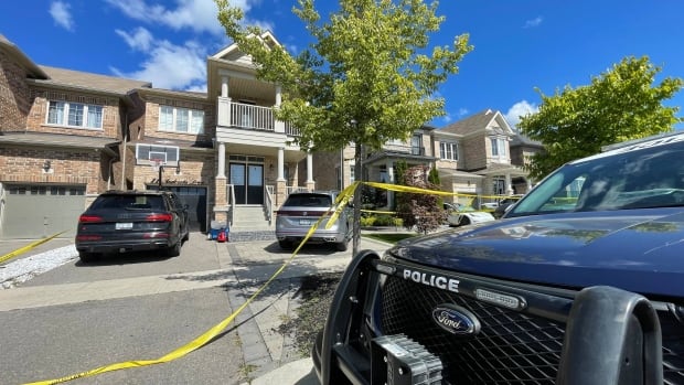 Police seen in front of a residential home.