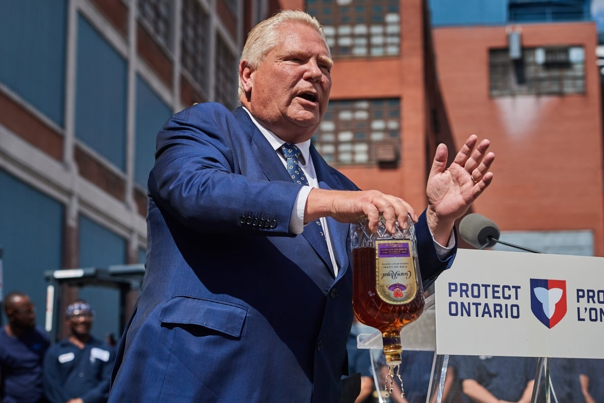 A man pours out a bottle of whisky
