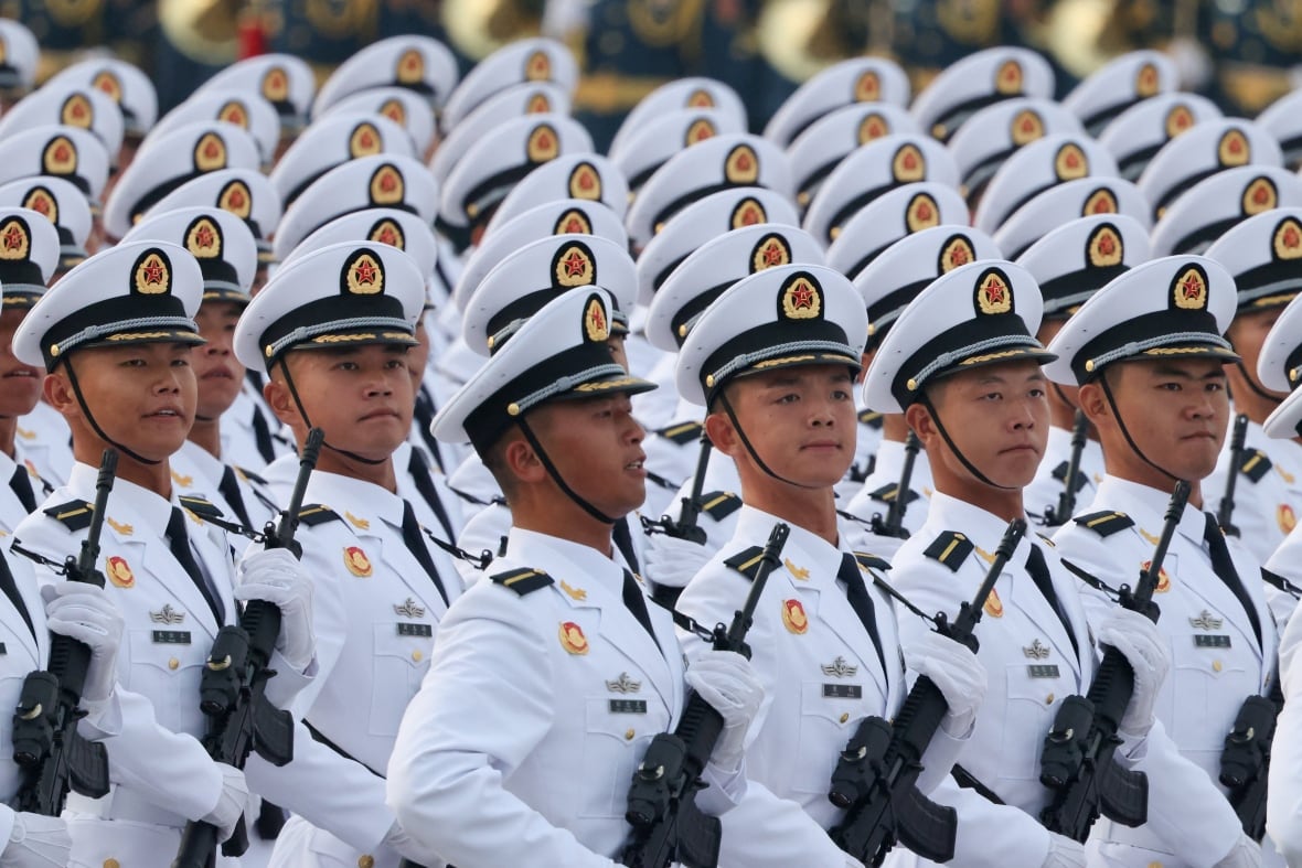 Army lines in white marching uniforms together