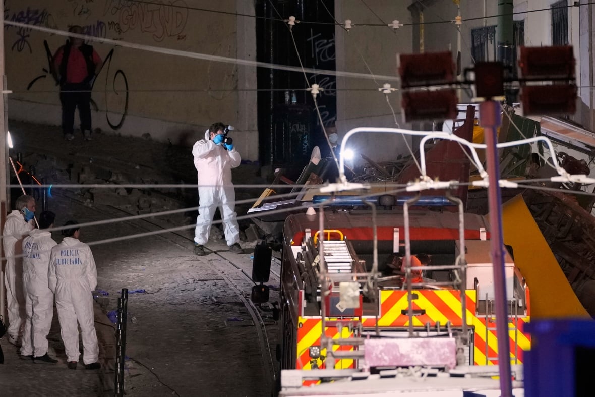 Investigators are seen at the site of a deadly funicular accident in Lisbon, Portugal.