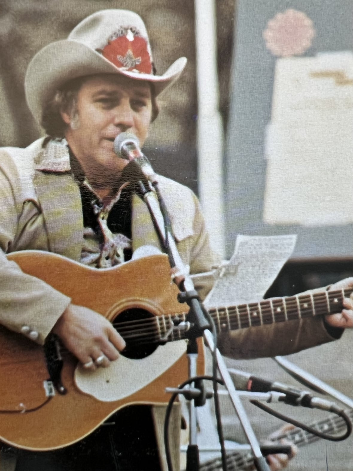 A man in a cowboy hat with a guitar.