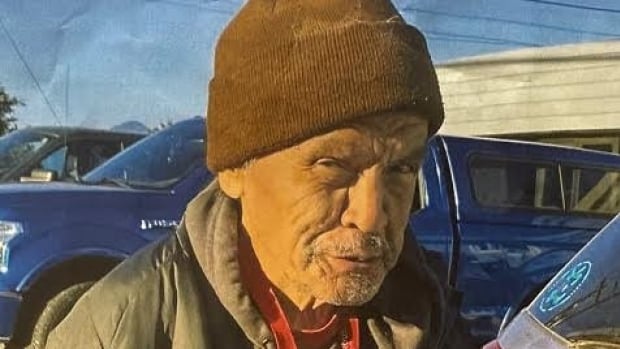 63-year-old Edward Vickers shown wearing a green jacket, black hoodie, black pants, and a brown toque. 