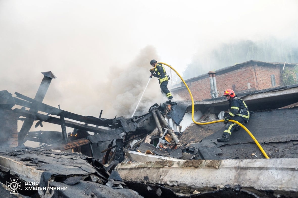 Firefighters are displayed on the surface of the building, using hoses with high smoke and damage to the building and debris.