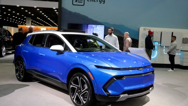 A blue car with a white roof indoors