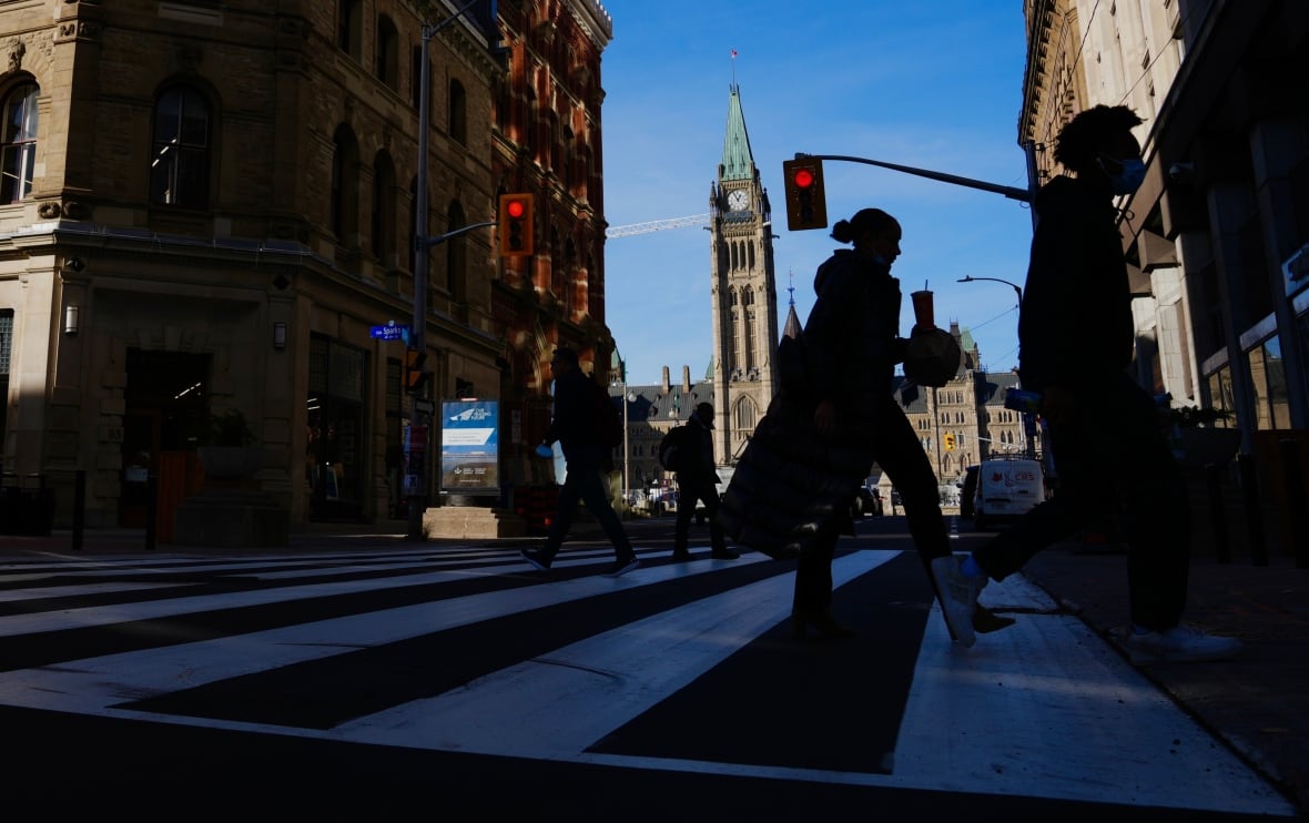 Pedestrians cross a street