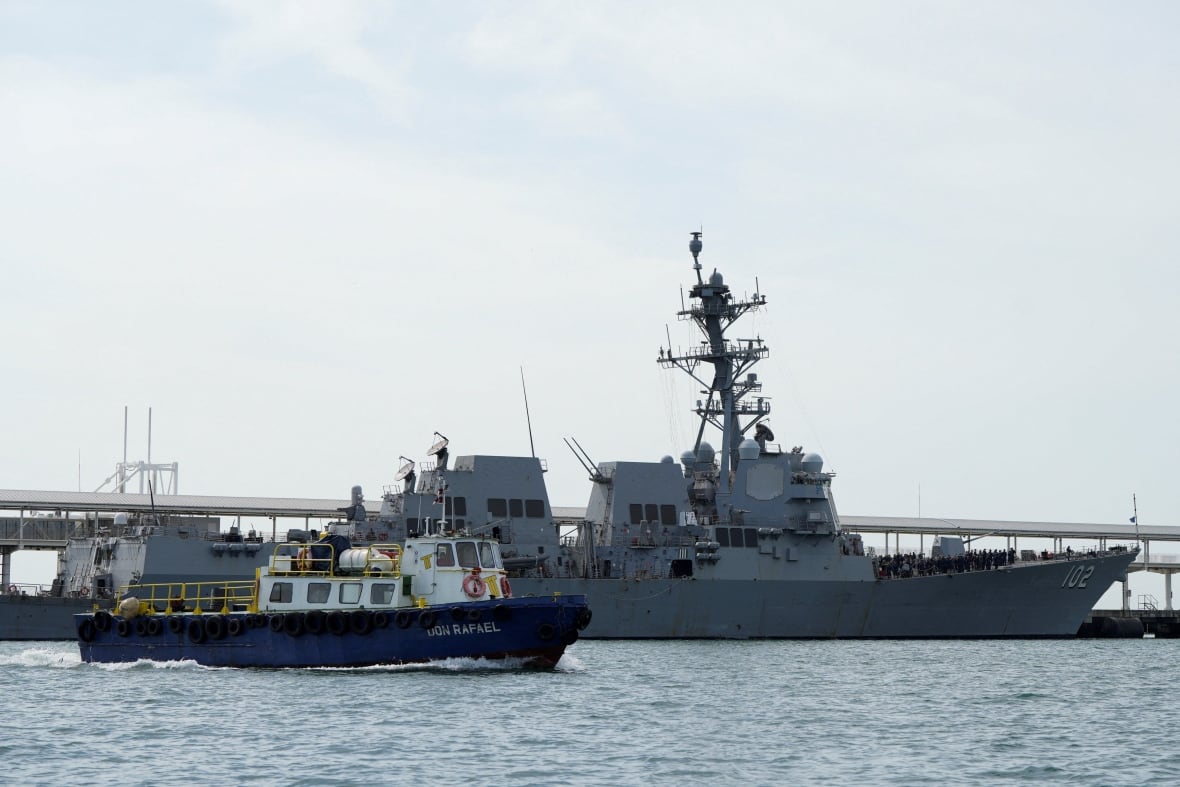 A large warship appears in a water body, with a smaller bowl nearby.