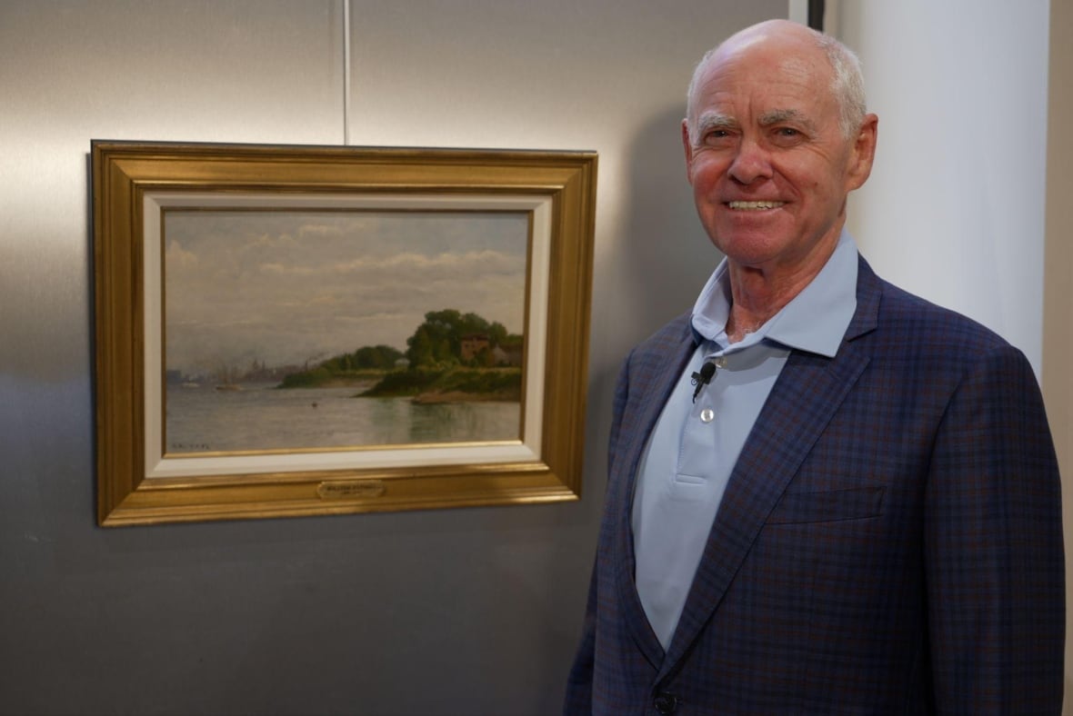A man who poses next to a painting.