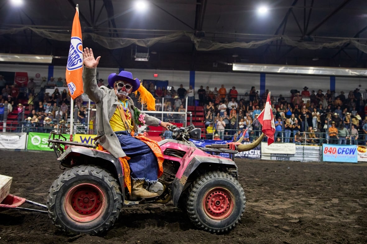 A clown in a quadbike.