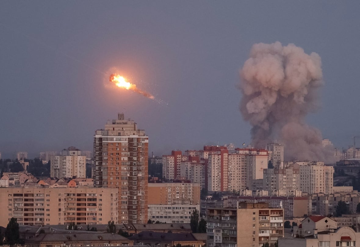 A view of the horizon is represented with a plume of smoke rising to the right and the flash of a missile shot down to the left above the buildings