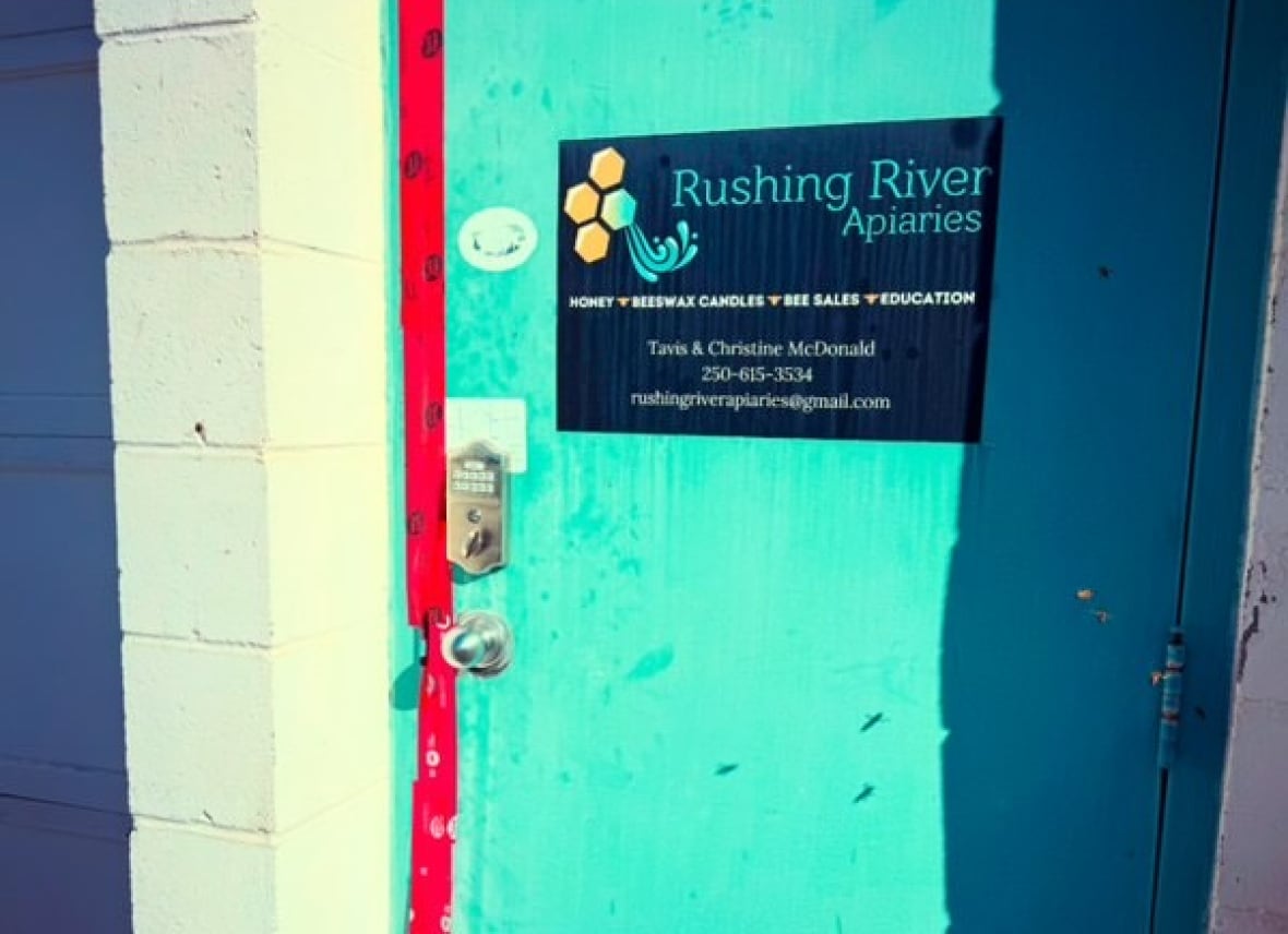 A blue door with an apiarium sign of the hurried river stuck with the bureaucracy.