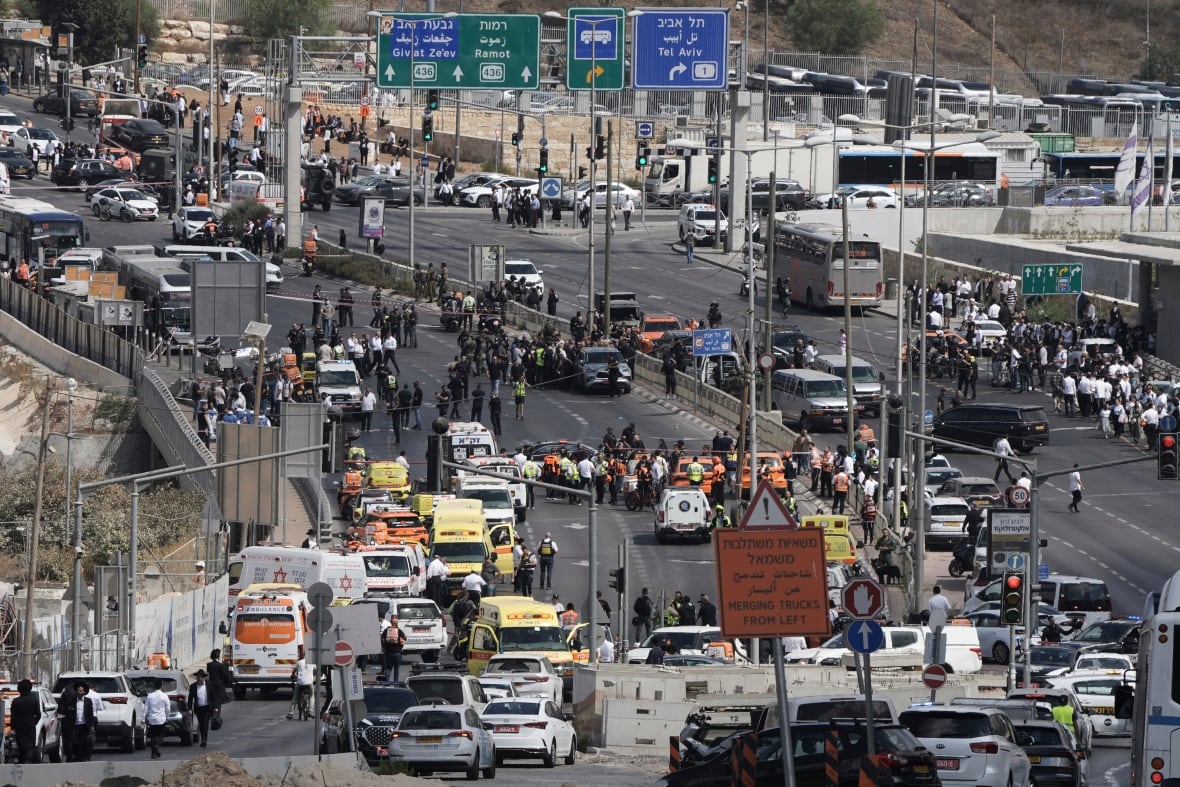 A wide view at a high level of an animated highway, which was taken up by an emergency scene.