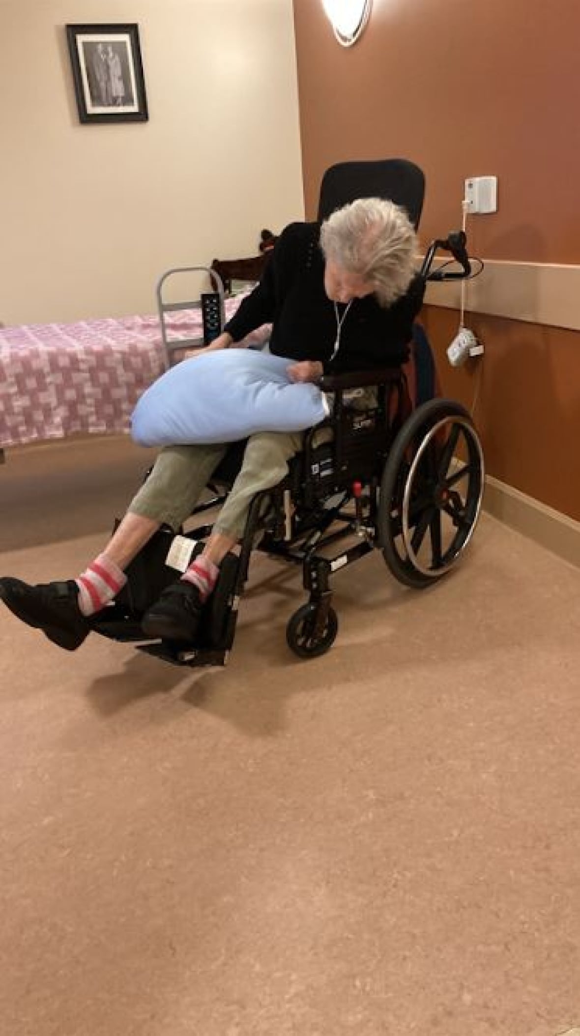 An elderly woman in a wheelchair 