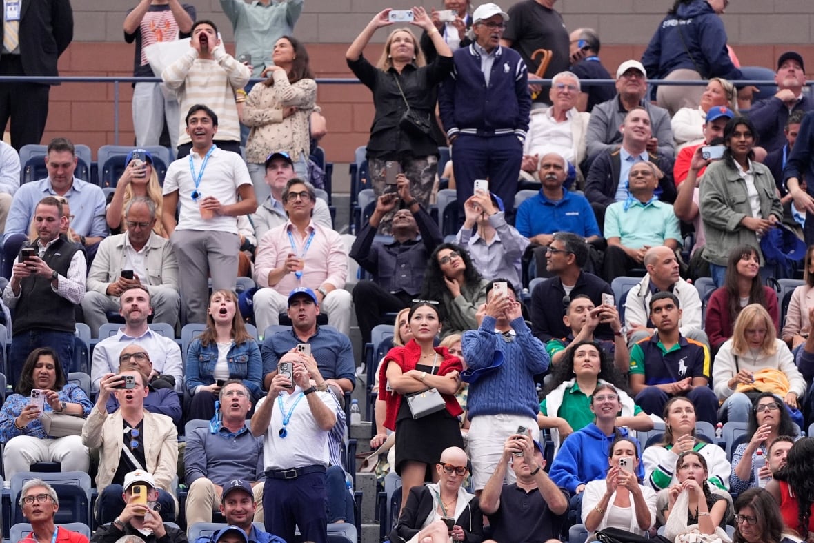 A crowd reacts