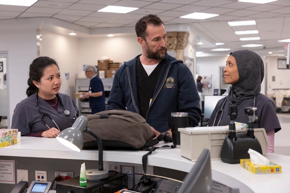 A doctor is flanked by two nurses.