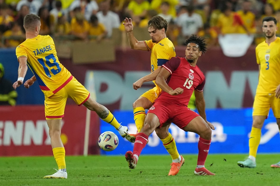 A soccer player battles for the ball.