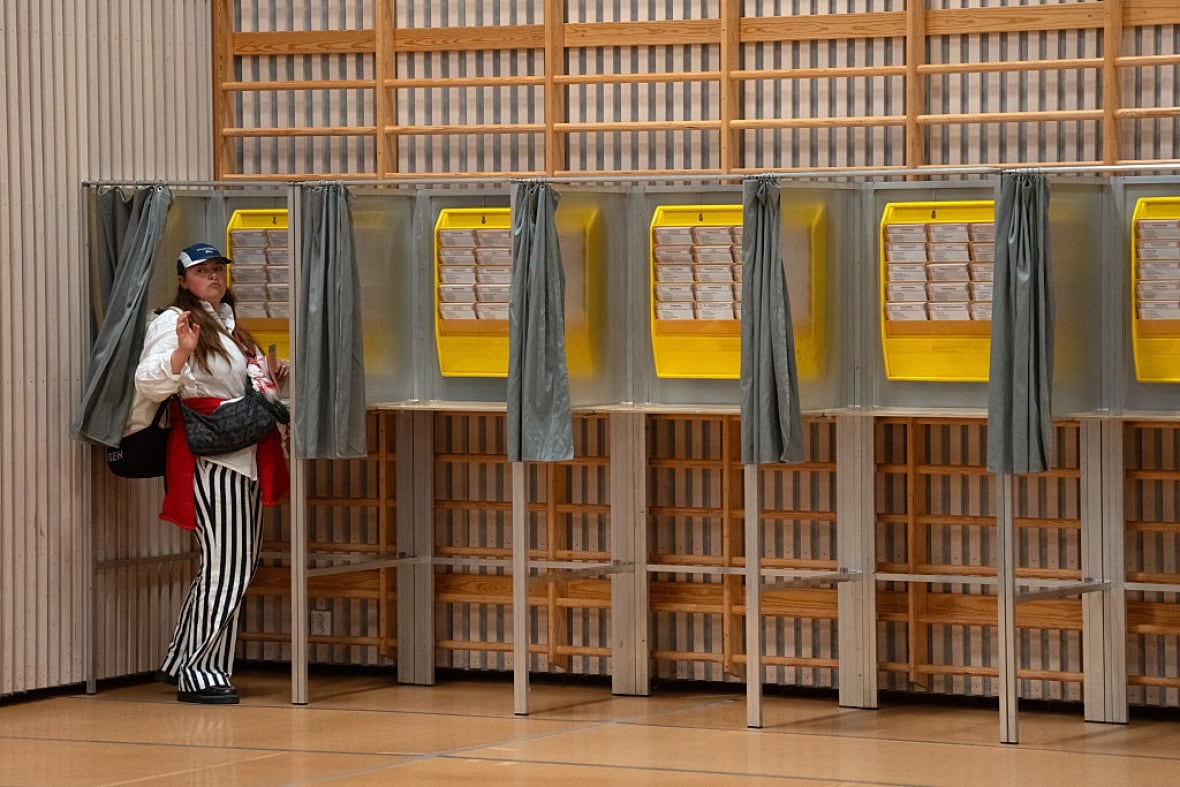 The woman standing near the poll station in Oslo, Norway.