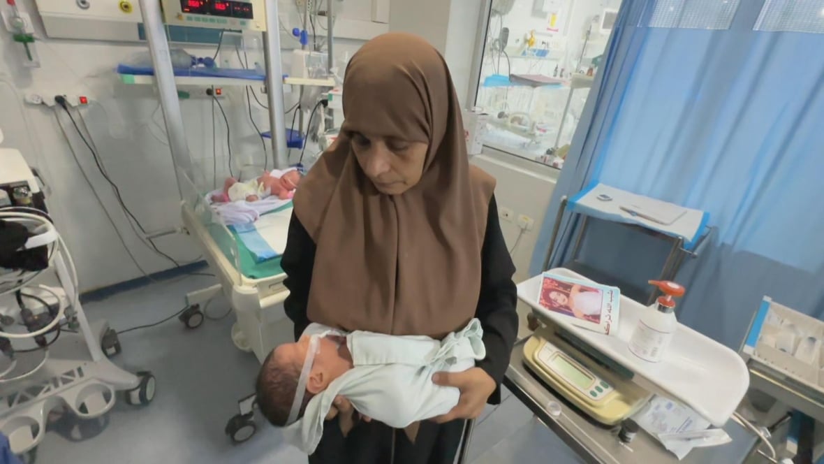 A woman holds a baby in her arms in the hospital.
