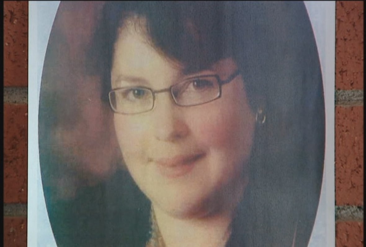 A photo of a woman with dark hair and glasses.