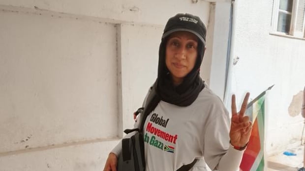 A woman flashes a peace sign