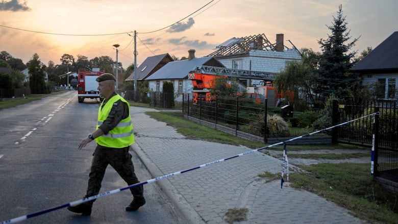A soldier walks near a house damaged by a fragment of a suspected Russian drone shot down after intrusions into Polish airspace, in Wyryki municipality, Poland September 10, 2025.  