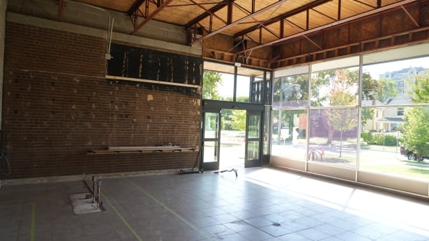 The inside of an old beer store stripped to the brick walls and rafters. 
