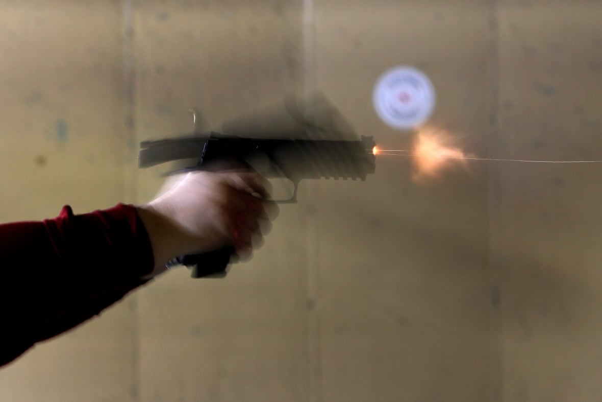 A blurry photo of a gun being shot at a firing range.