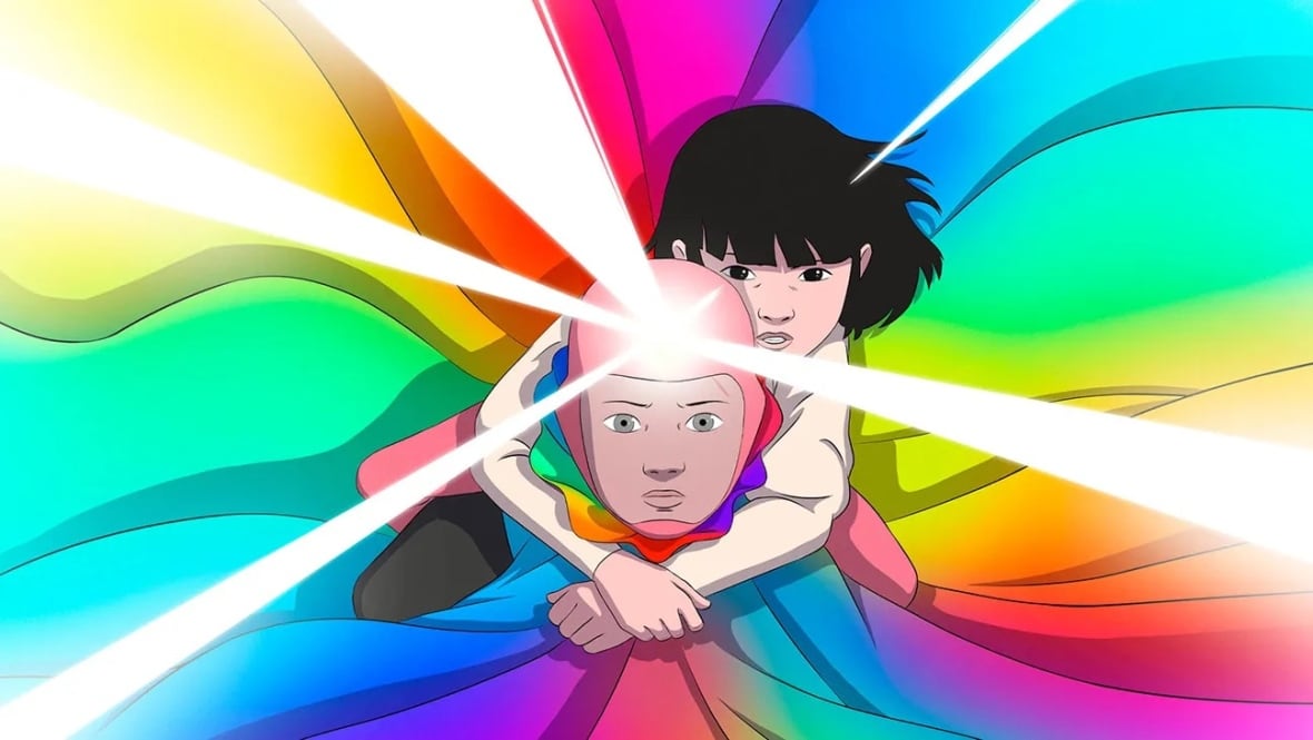 A child is shown, wearing a rainbow-coloured cape that covers the entire frame behind him. Holding onto his shoulders is a little girl. 