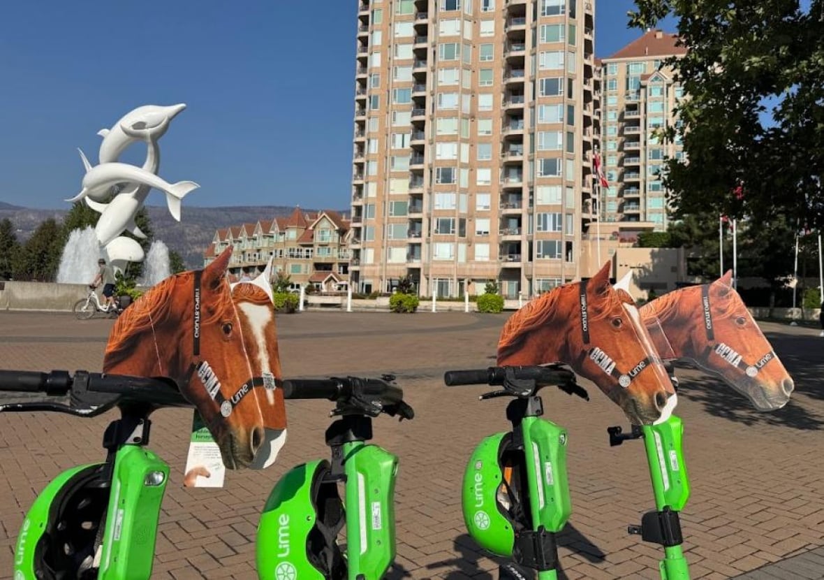 Lime scooters topped with cardboard horse heads
