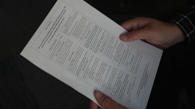 Hands holding a document.
