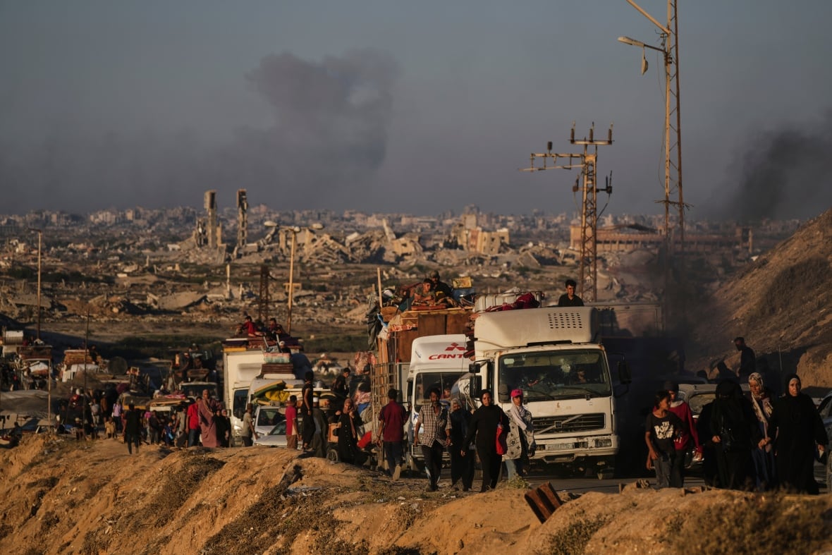 People and cars roam the road as the repeals and the black smoke appeared in the background.