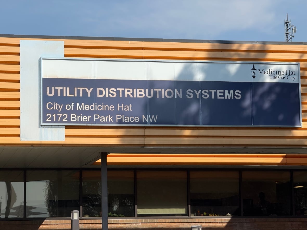A gray and brown building with a sign reading Utility Distribution Systems on it.