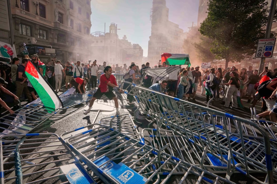 Protesters block a road with barricades.