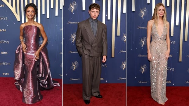3 people pose for photos on the red carpet. 