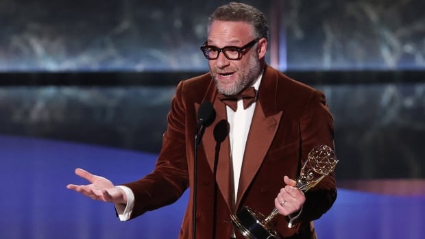 An ecstatic man speaks into a microphone