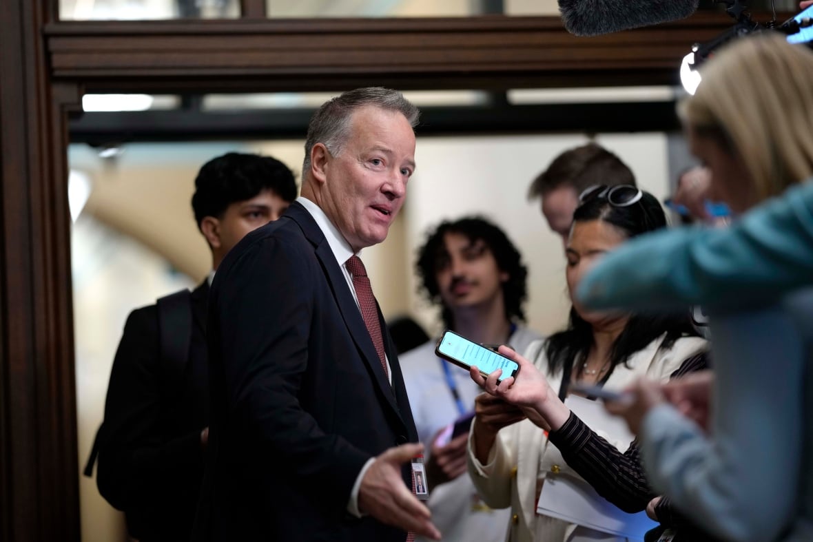 A man speaks to reporters.