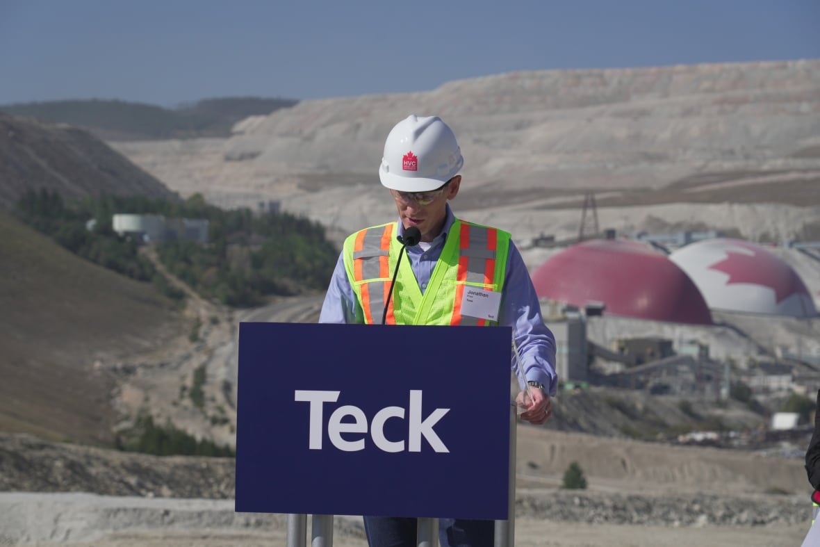 A man in a high-vis vest at a Teck platform outside a mine site.