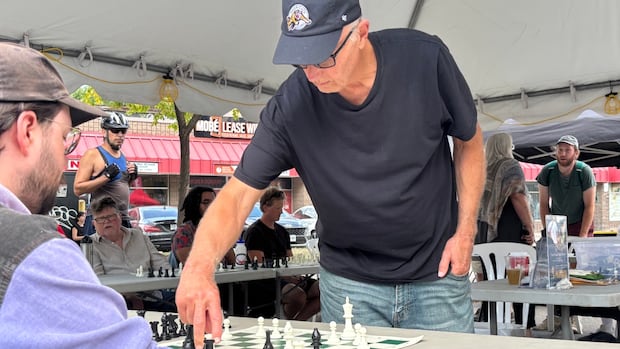Dozens test their skills against international chess master Brian Hartman in his hometown of Hamilton
