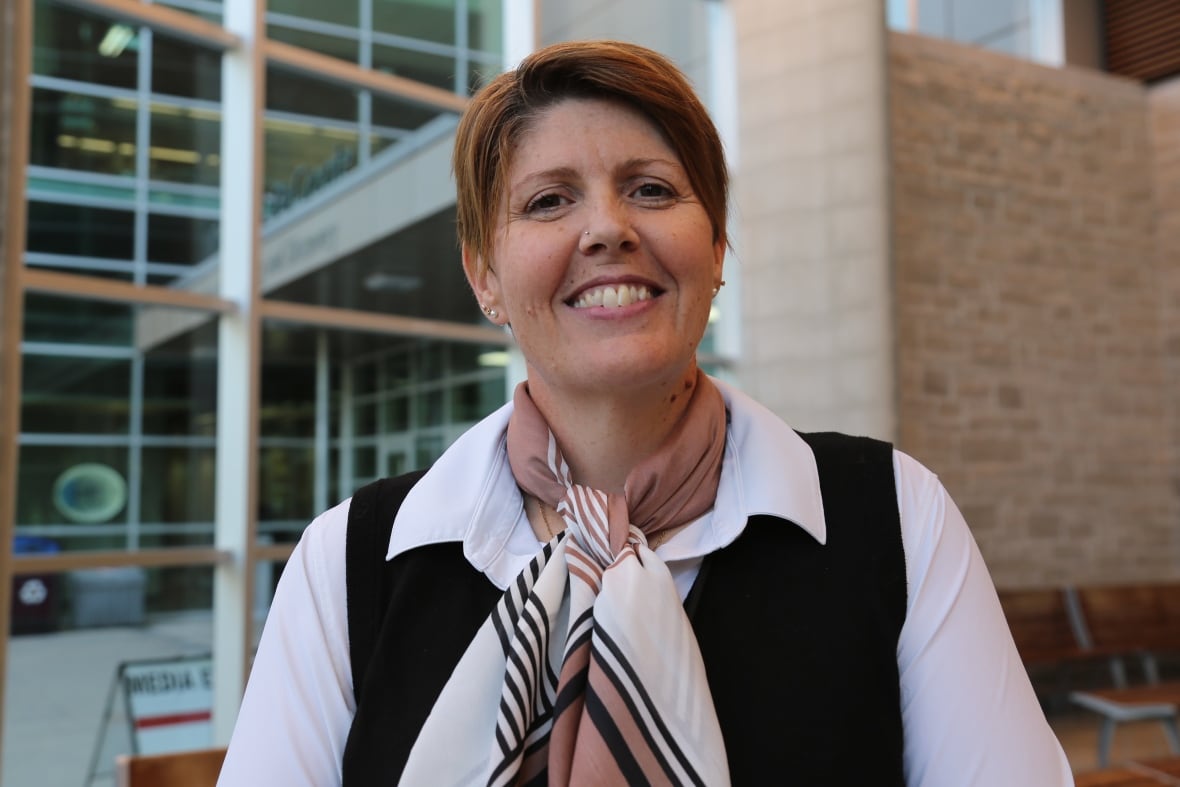 lead researcher smiling at an atrium campus