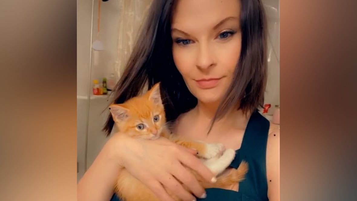 Woman holding a cat.