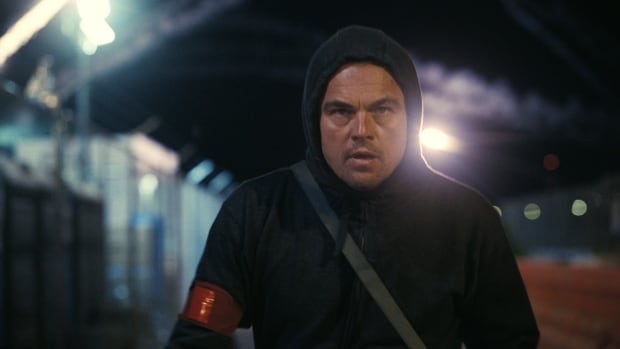 A man in a hood is shown. 