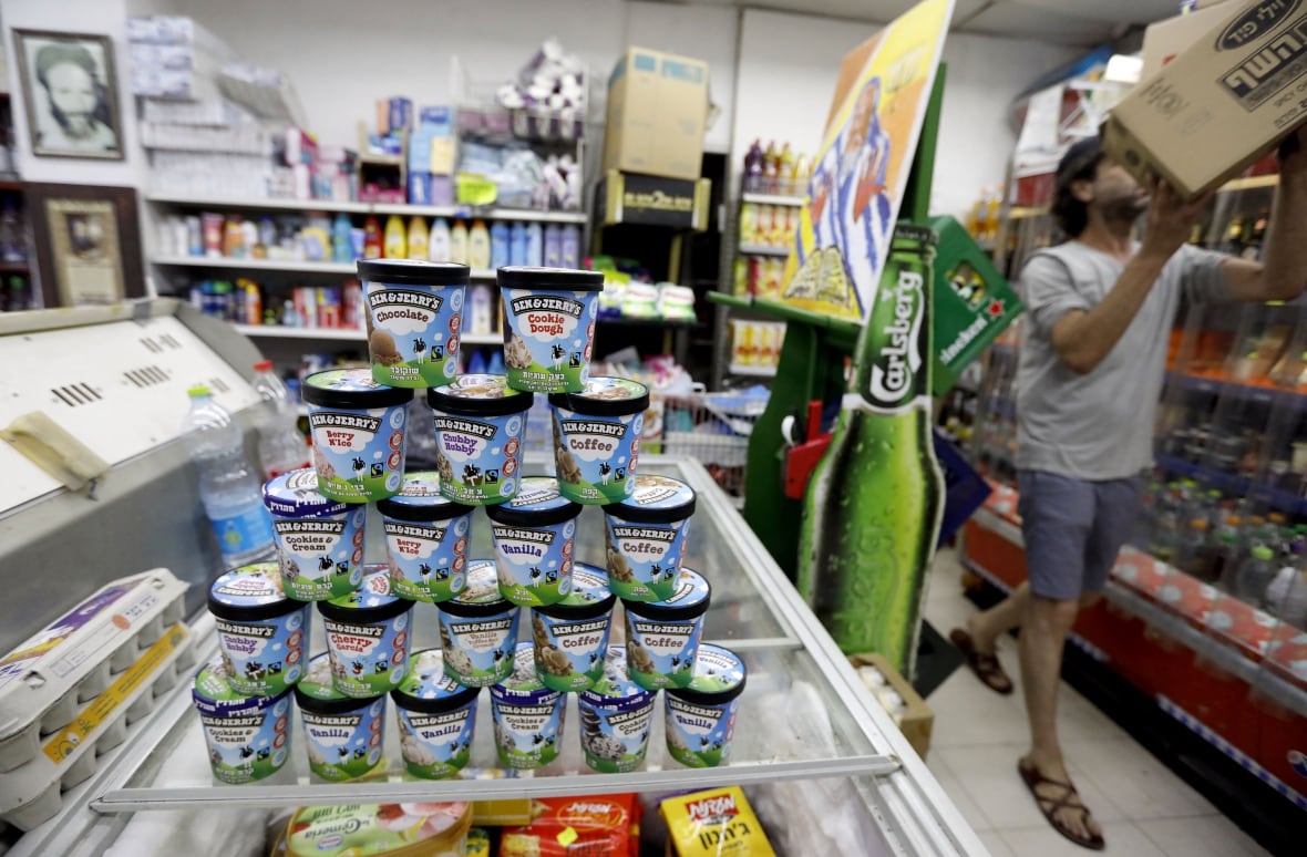 A display of pints of ice cream is shown in what appears to be a convenience store.
