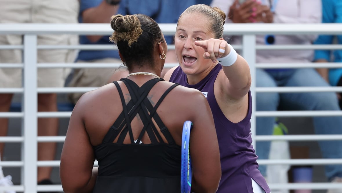 Tennis players argue two women after their match.