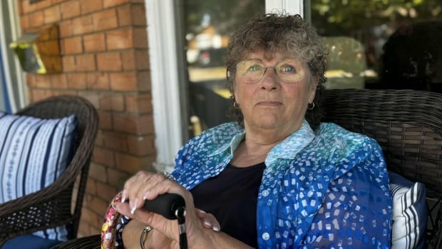 A woman sitting in a chair outside